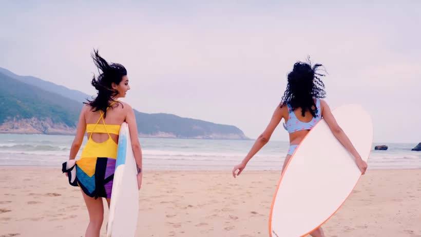 Two women with surfboards